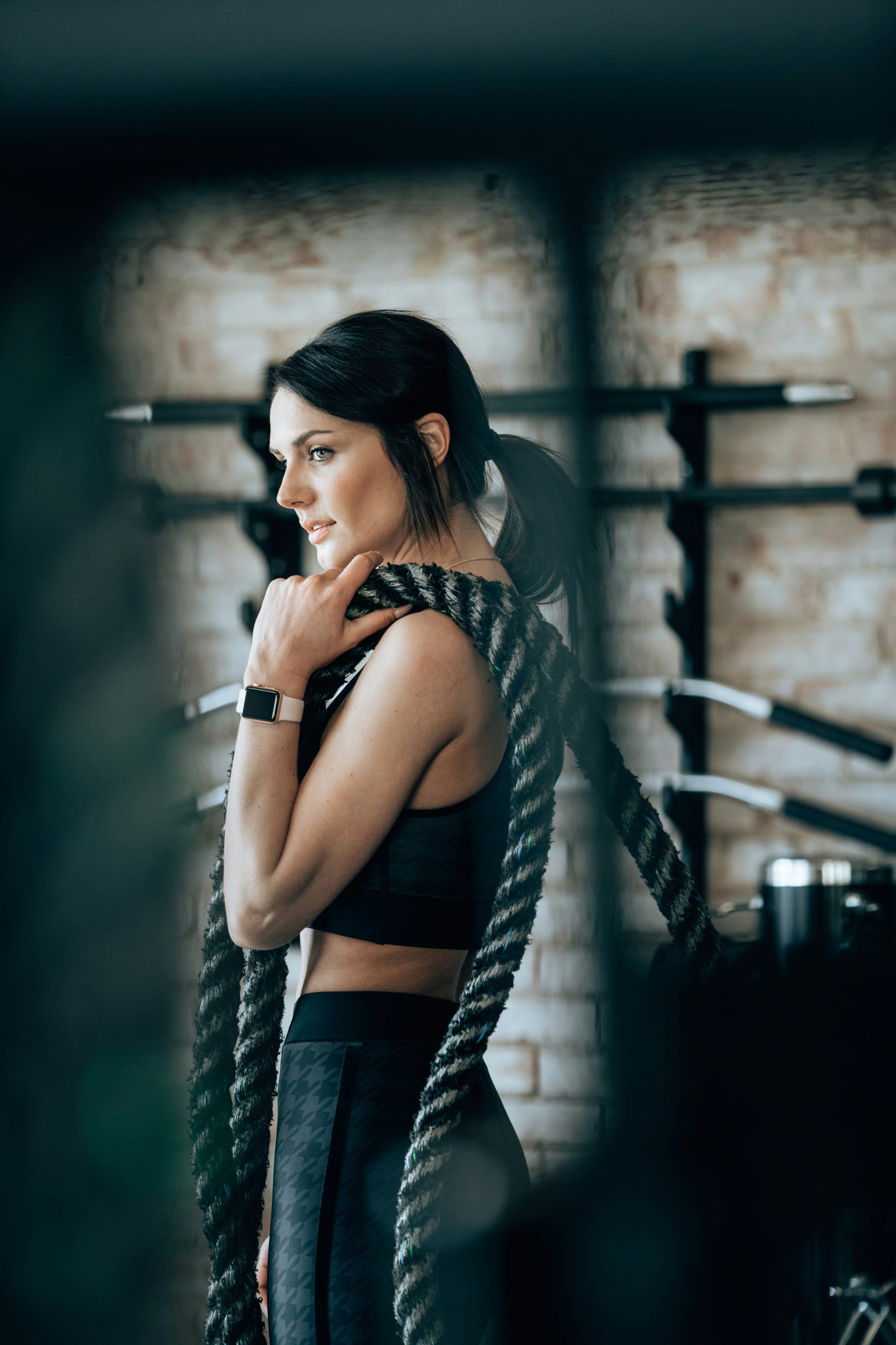Athlete recovering with battle ropes in a gym.